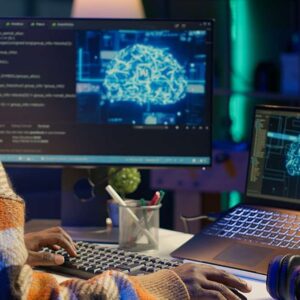 AI for Data Analytics & BI. Coder using AI software on computer. Data science, machine learning, and business intelligence.
