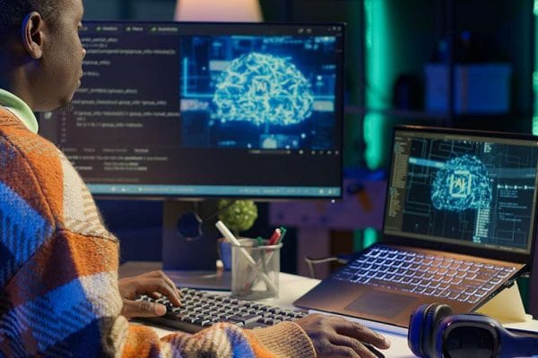 AI for Data Analytics & BI. Coder using AI software on computer. Data science, machine learning, and business intelligence.
