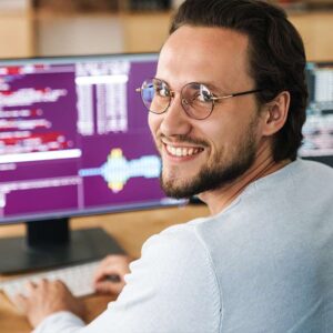 AI for HR Professionals: Man smiles at computer screen with code. AI in HR concept.