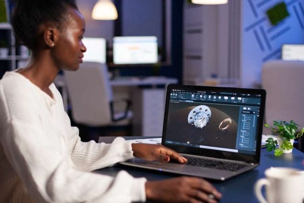 AI for Product Management: Woman using AI on laptop. Product design and development with AI.
