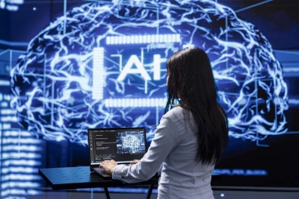 AI for Programmers: Woman coding with AI brain graphic. Artificial intelligence development concept.