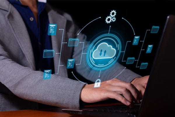 AWS Cloud Practitioner: Person using laptop with cloud computing graphic overlay.
