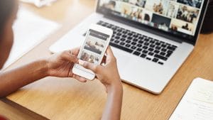 Creating styled responsive sites. Woman viewing website on laptop and mobile phone. Responsive design.