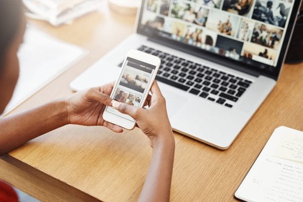 Creating styled responsive sites. Woman viewing website on laptop and mobile phone. Responsive design.