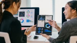 Data for Decision-Makers: Businesswomen analyze charts and graphs. Data-driven decisions.