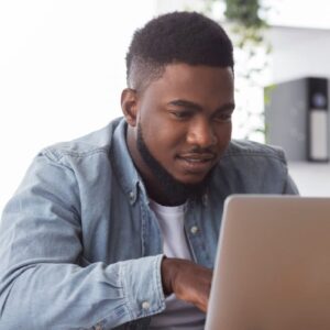 Geography student using laptop. Adult matric student studying online.