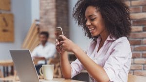 Life Sciences: Smiling woman with laptop and phone. Adult education, matriculation.