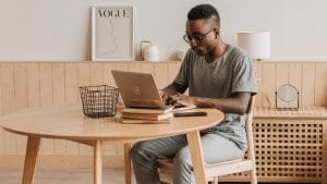 Bookkeeping training: Man studies on laptop. Further Education and Training Certificate in Bookkeeping.