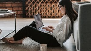 Woman studying Financial Accounting online with laptop. ICB National Diploma course.
