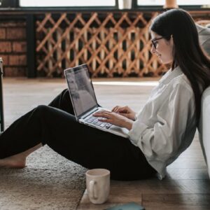 Woman studying Financial Accounting online with laptop. ICB National Diploma course.