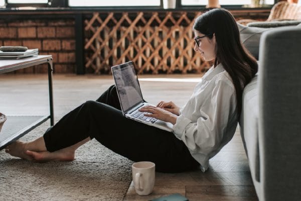 Woman studying Financial Accounting online with laptop. ICB National Diploma course.