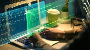 Ruby on Rails Full Stack Developer. Hands coding on laptop with code overlay. Software development, programming.