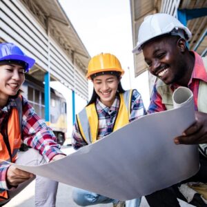 NEBOSH International General Certificate in Occupational Health and Safety students. Construction workers reviewing plans.