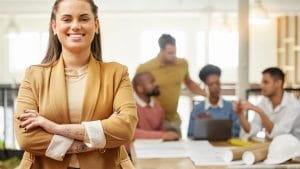 Confident woman leading finance training for non-financial professionals. Diverse team collaborating.