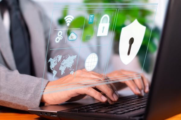 Cyber resilience and risk management. Person typing on laptop with security icons. Data protection and cybersecurity.