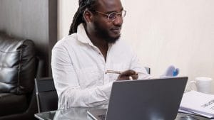 Go Programming Essentials: Man with laptop studying Go. Learn Go programming language. Online Go course.