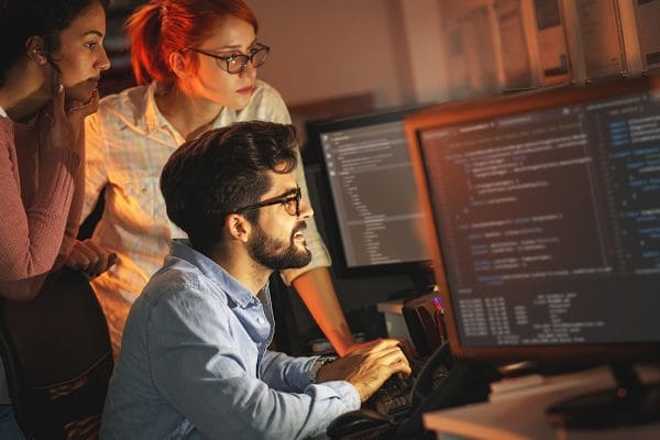 Machine learning specialist team working on code. Programming principles.