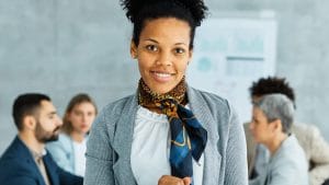 Confident office manager with tablet. Business meeting with diverse team. Office Manager Journey.