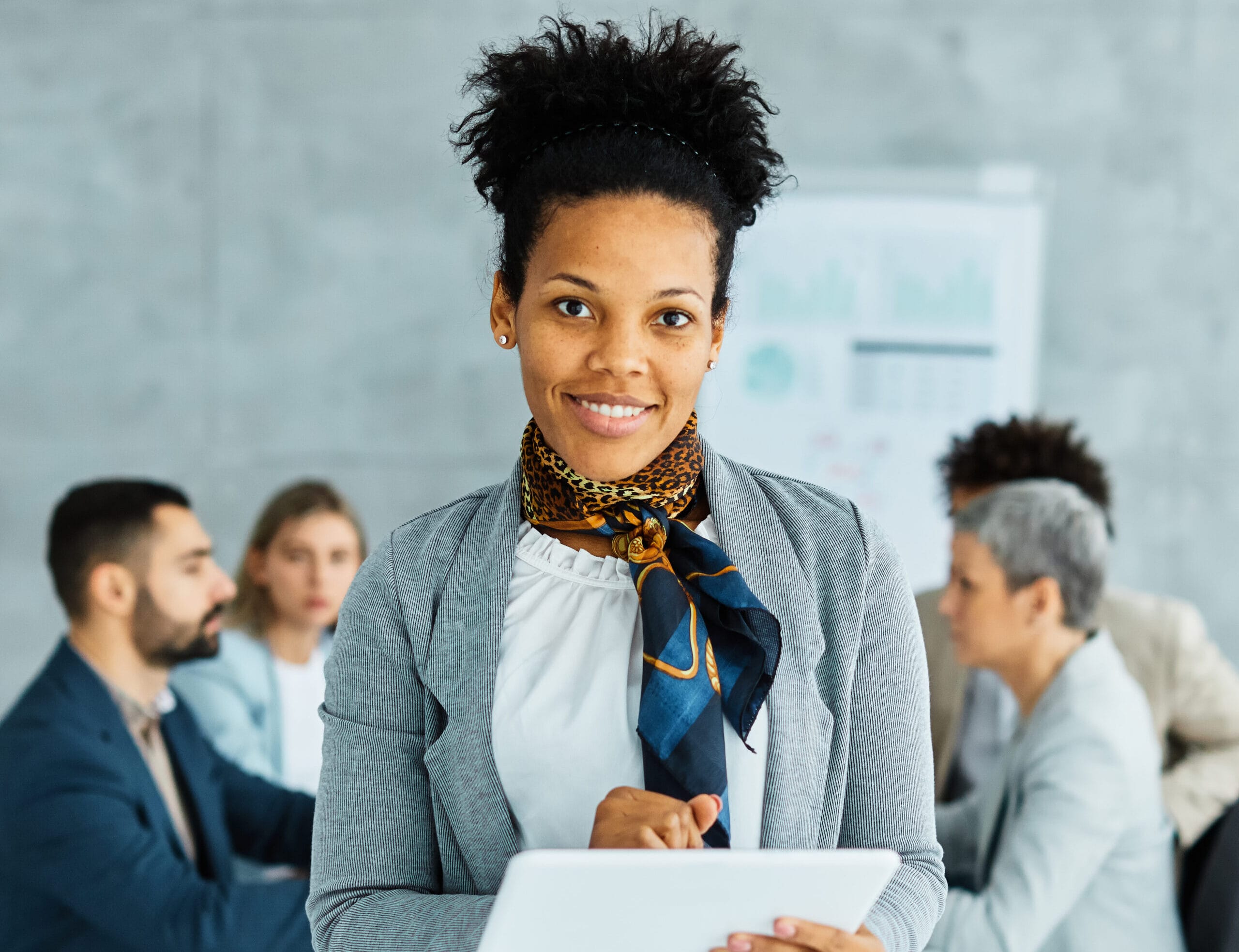 Confident office manager with tablet. Business meeting with diverse team. Office Manager Journey.