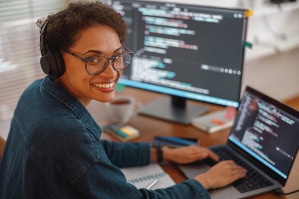 Woman coding Python on laptop. Pythonista to Python Master. Programming, development, software engineer.