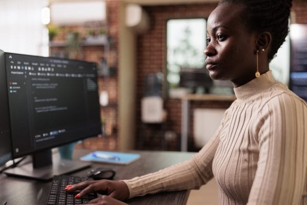 Woman coding Swift. Programmer at computer. Swift beginner to intermediate level.