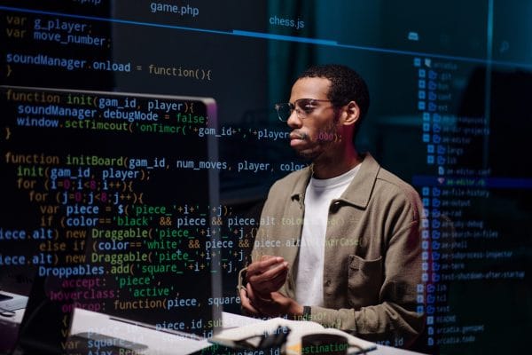 Systems engineer working on code. Man with glasses coding. Software development. Systems Engineering Journey.