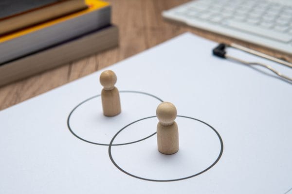 Communication essentials concept. Wooden figures in circles, representing interpersonal skills. Teamwork and collaboration.