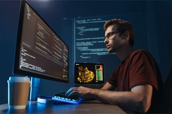 CompTIA Cloud+ candidate coding. IT professional working on cloud technology.