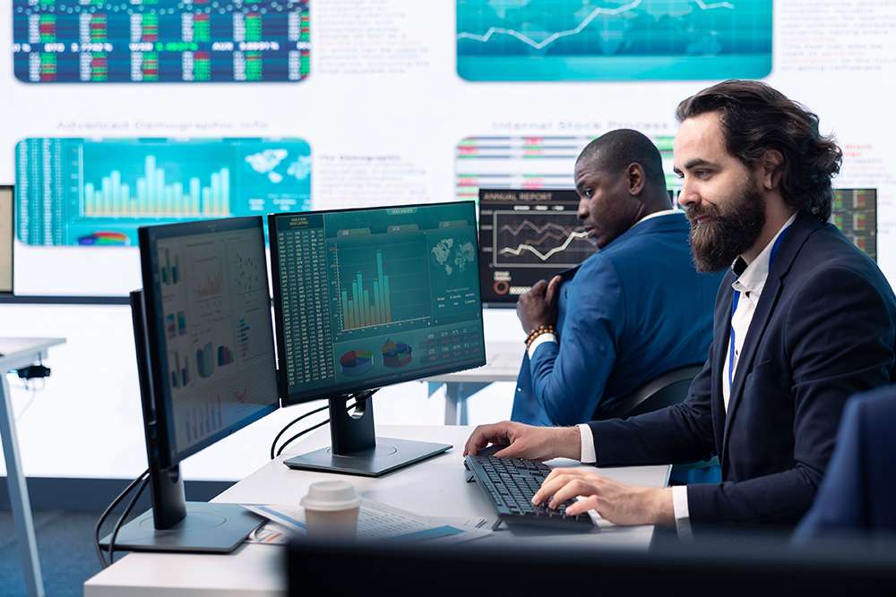 CompTIA Data+ professionals analyzing data on screens. Data analysis, charts, and graphs are visible.