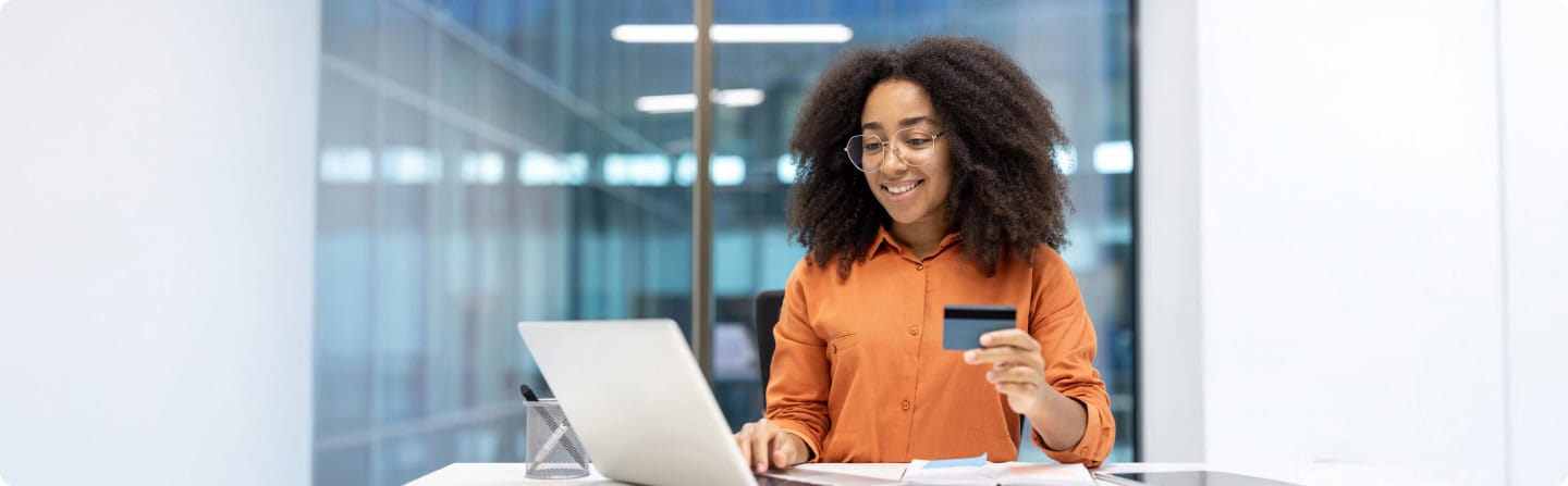 Woman pays online with credit card. Using laptop for secure payment.