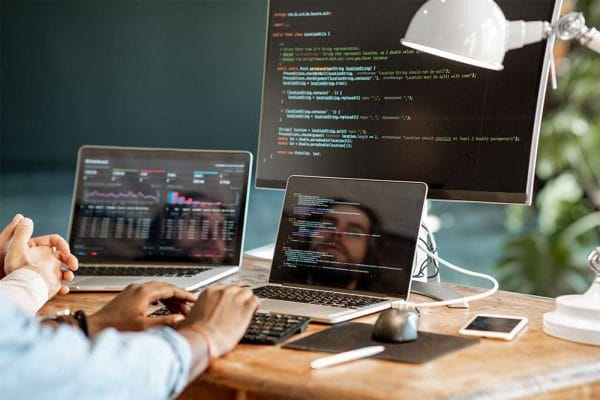 Data analyst to data scientist: Coding on multiple screens. Data science, programming, analytics.