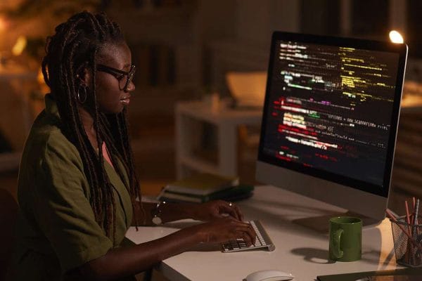 Enterprise developer working on DevOps. Woman coding on computer. Software engineer at desk.