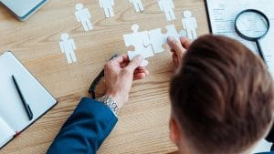 Human Resources Consultant connecting puzzle pieces. Recruitment, resume, and hiring concept.