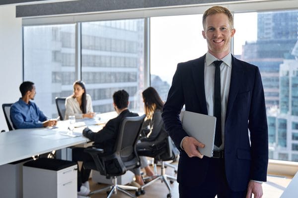 Leadership skills builder: Businessman with team in a modern office. Business meeting, leadership training.