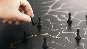 Strategic thinking concept. Hand moving chess pawn on network, planning business strategy.